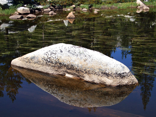 Granite boulder and its reflection