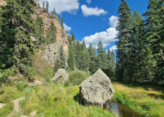 Boulder between path and river