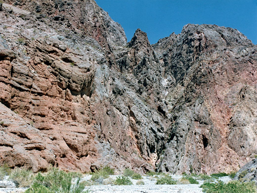 Eroded, weathered, reddish-grey cliffs