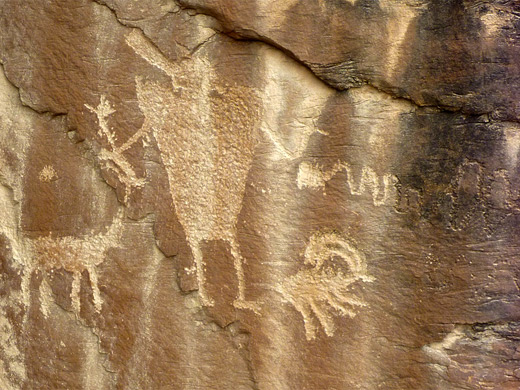 Hunter petroglyph with deer and bighorn sheep