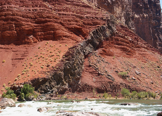 Basalt dike on the far side of the Hance Rapids