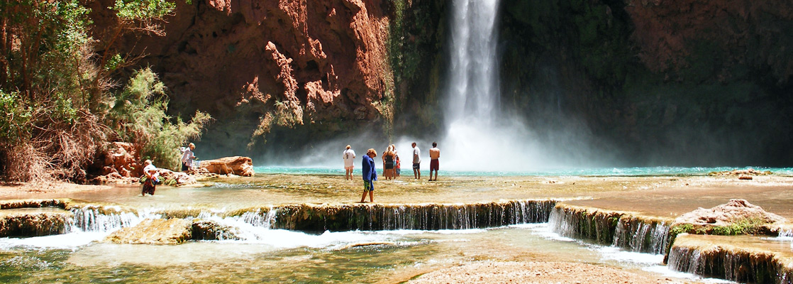 Hikers at the travertine terraces below Mooney Falls, in Havasu Canyon