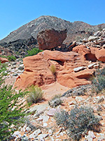 Black boulder on red rocks