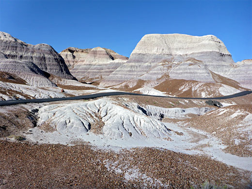 Paved path through purplish badlands