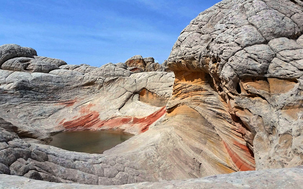 Pool amidst the swirling sandstone at White Pocket