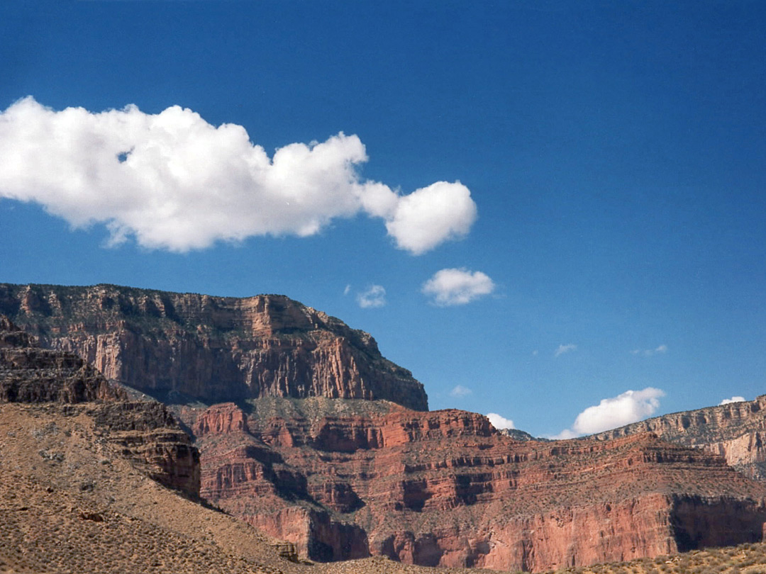 Clouds above red cliffs