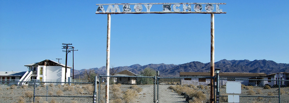 Gates to the abandoned school at Amboy