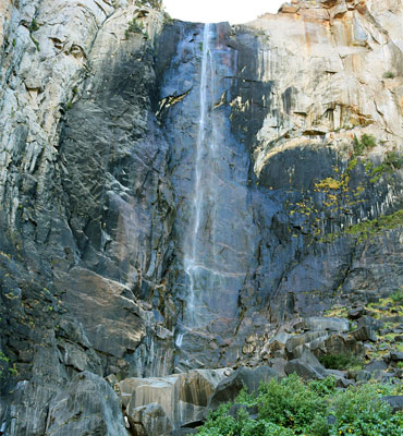 Bushes and boulders below the falls