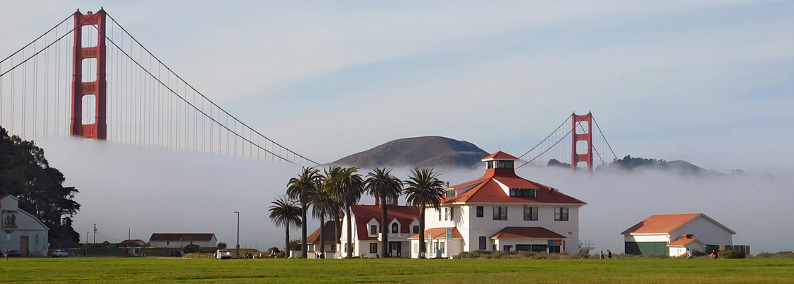 Golden Gate Bridge above buildings at Crissy Field