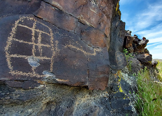 Two petroglyphs on a basalt cliff
