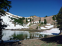 Snow-covered slopes at the edge of the lake