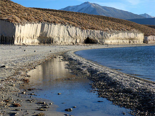 Pebble spit, forming a reflective pool; Mt Morgan in the distance