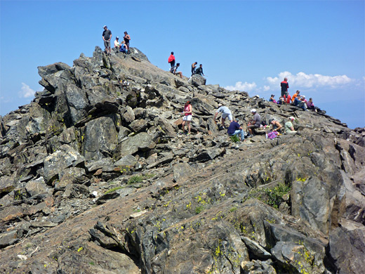 Many hikers at the rocky summit of Mt Tallac