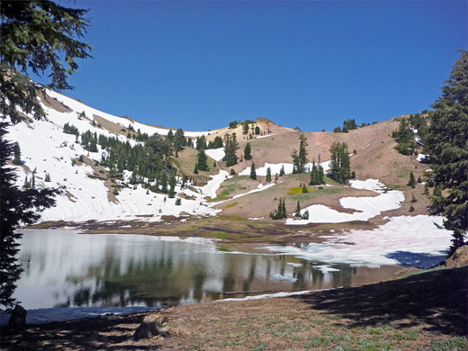 Snow-covered slopes at the edge of Ridge Lake