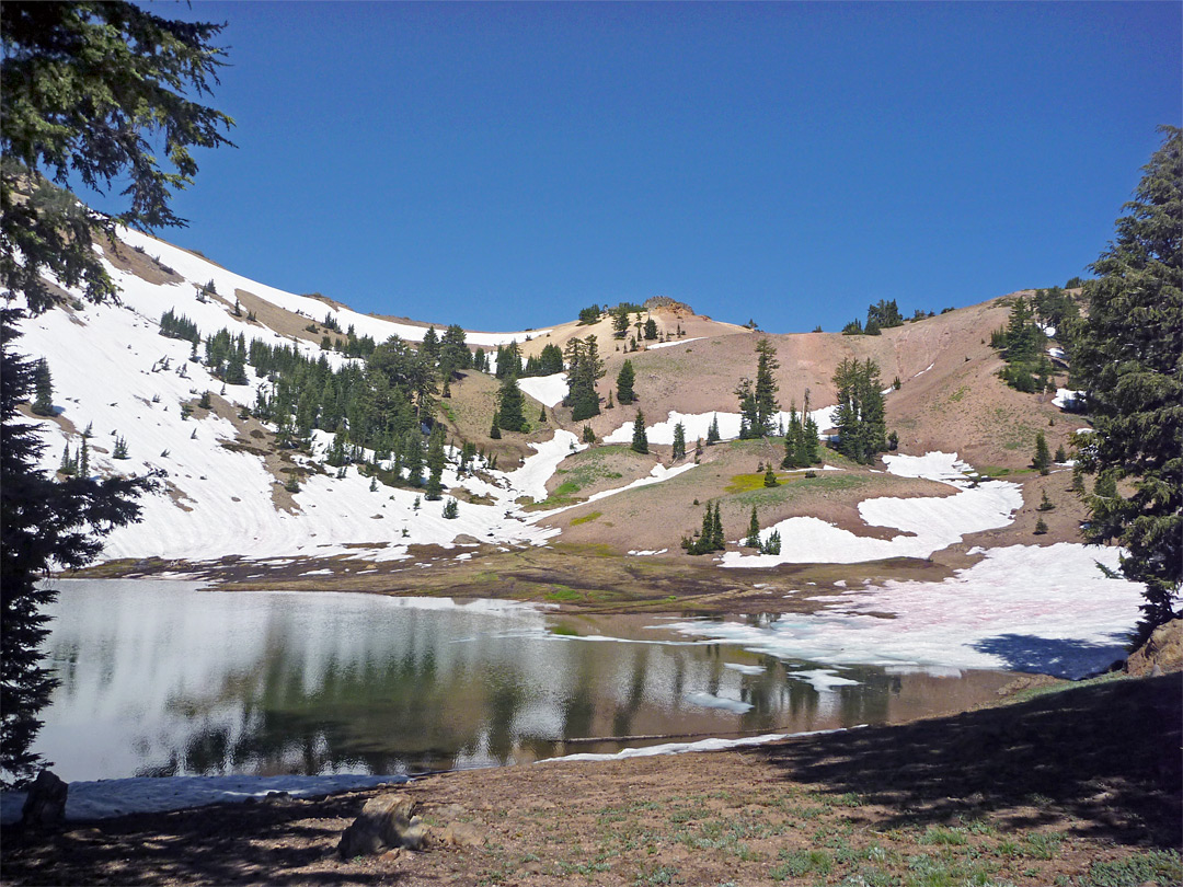 Snow-covered slopes at the edge of the lake