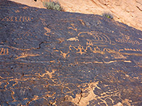 Petroglyphs on a dark rock