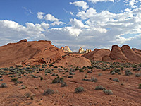 White domes beyond red rocks