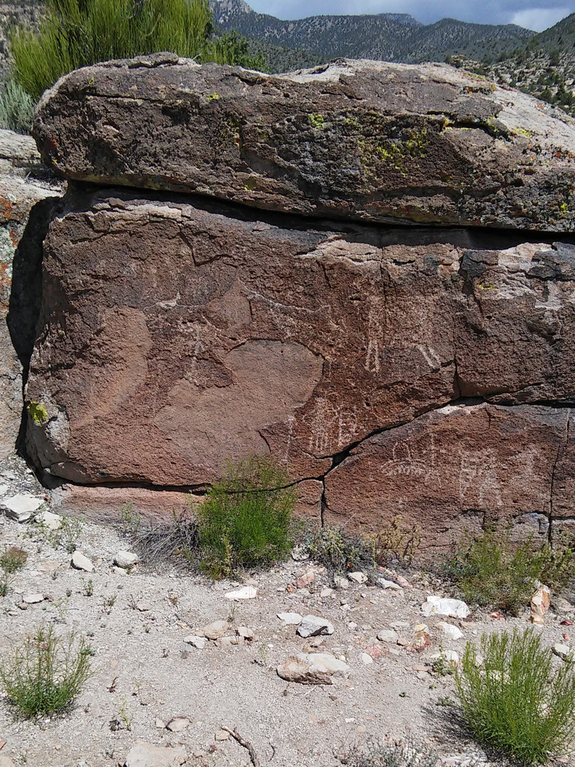 Petroglyphs on a dark boulder