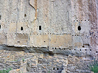 Post holes in a cliff