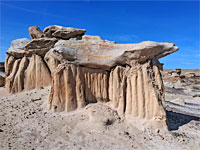 Boulders atop soft pedestals