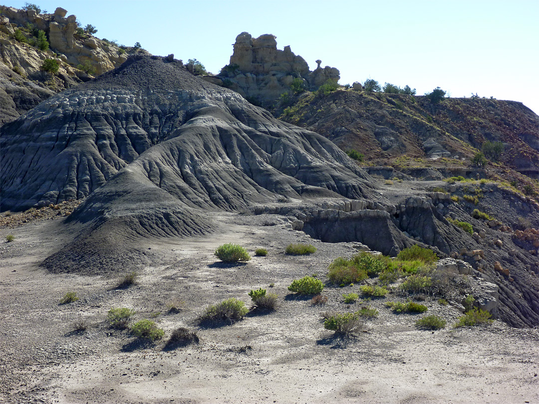 Eroded rocks above grey mounds