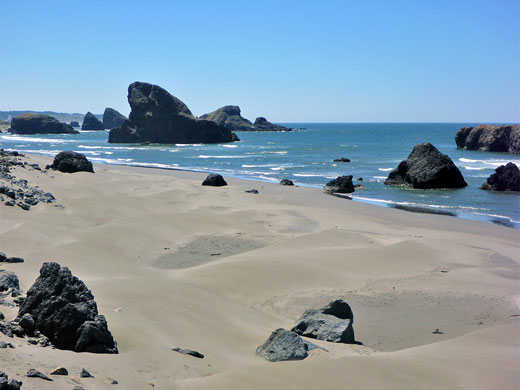 Offshore rocks and grey sand at Hunters Cove