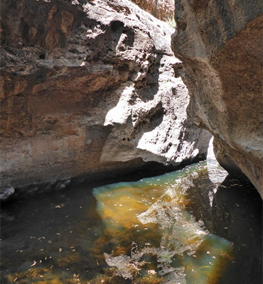 Pool between grey cliffs