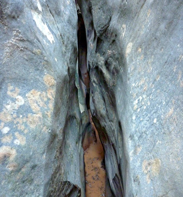 Grey rocks enclosing the narrowing canyon