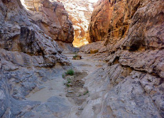 Sunlight at the end of a long shadowy passage