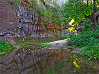 Reflections of a streaked cliff