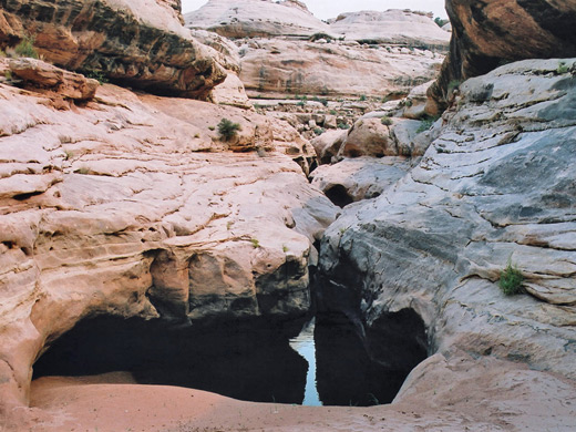 Dark pool beneath overhanging rocks