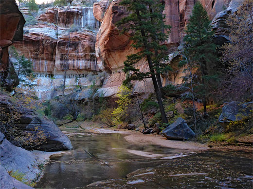 Trees, pools, boulders and cliffs