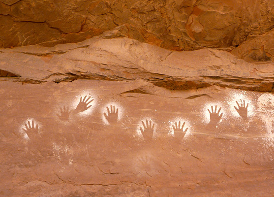Row of eight white reverse handprint pictographs, site 2