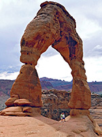 Hikers below the arch