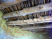 Roof timbers and yellow adobe