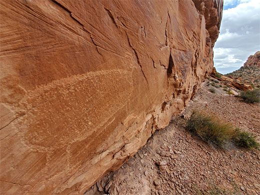 Bighorn sheep petroglyph on a vertical cliff