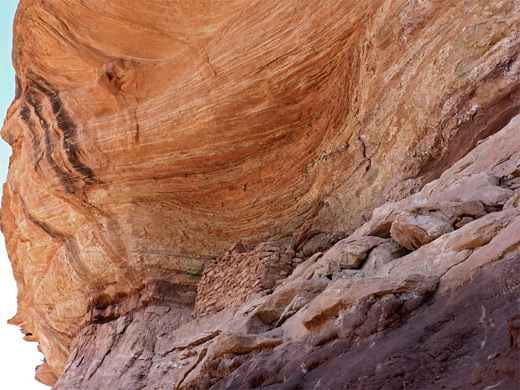 Ledge ruin below a colorful, sandstone alcove