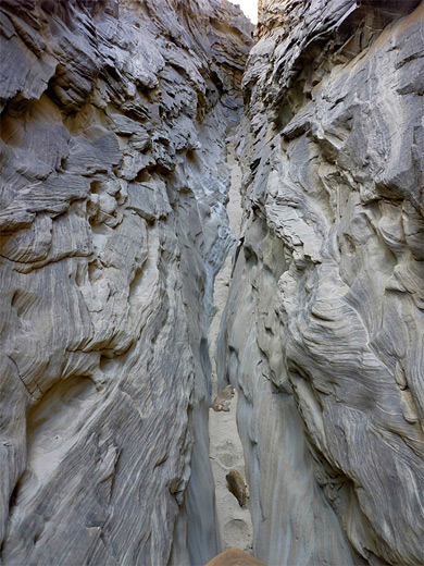 Passage through jagged, striated rocks