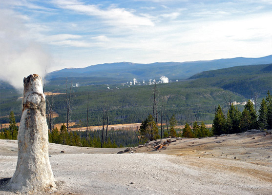 Monument Geyser; in the distance are steam plumes above Norris Geyser Basin
